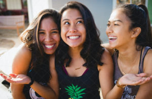 A group of young girls happily smiling as they enjoy their time with each other