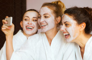 A group of three girls taking a selfie as they enjoy a teenace detoxifying facial