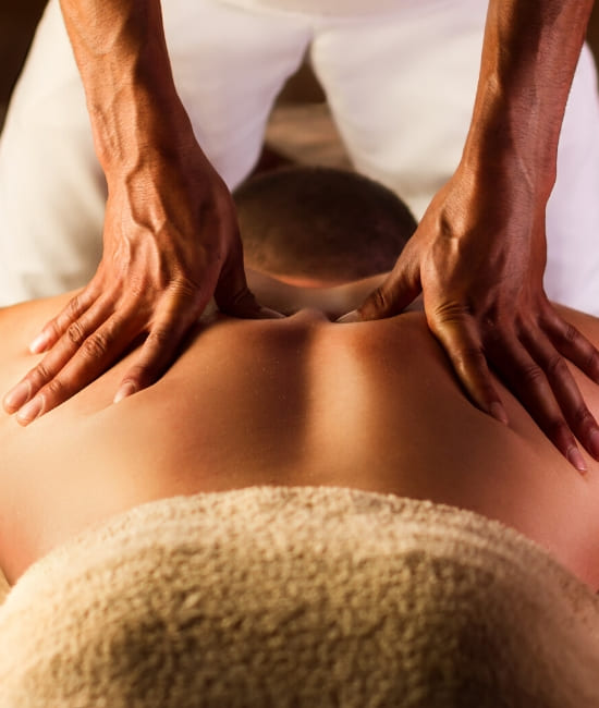 A man receiving a deep tissue massage on his back