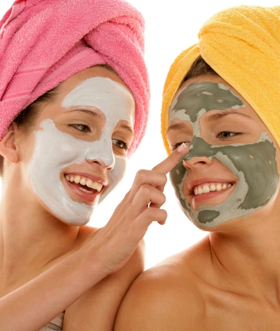 A couple of teenage girls enjoying a detoxifying teenage facial